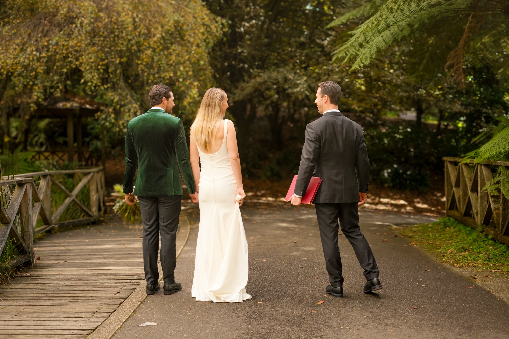 Jack Anderson walking with a couple after their ceremony